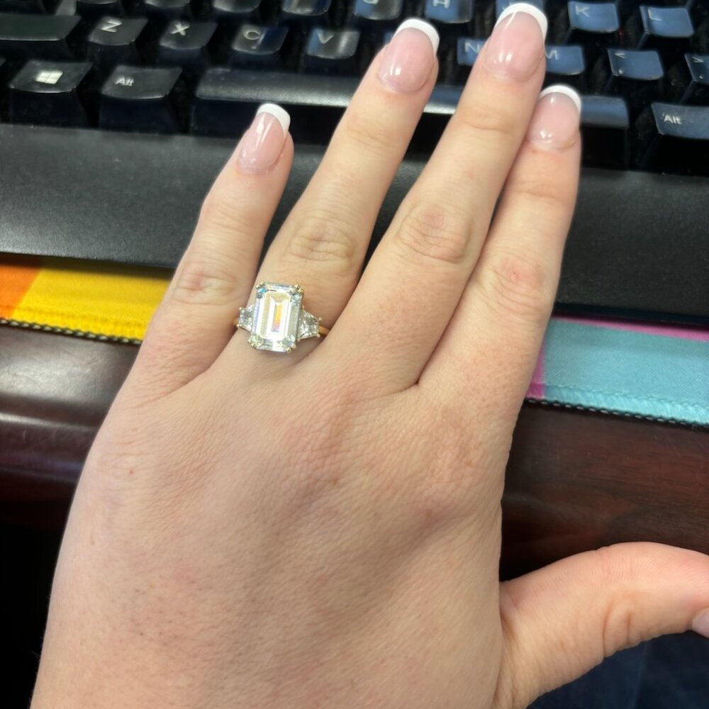 Emerald Cut Forever One Moissanite Engagement Ring, featuring trapezoid stones